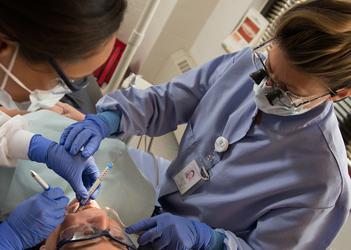 A UB student performing dental work on a patient